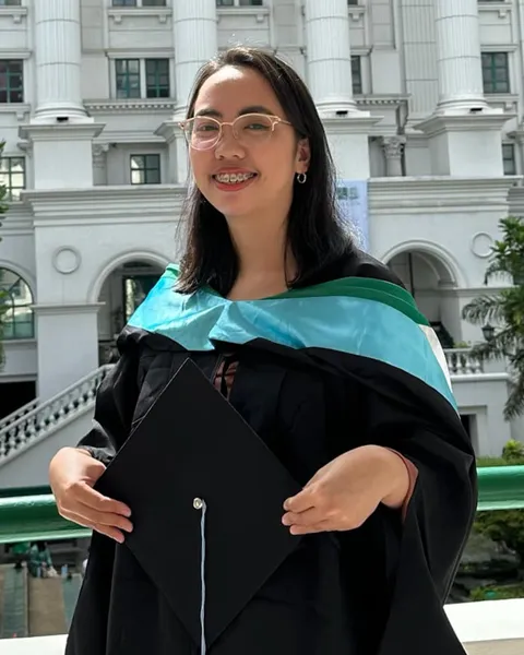Joyce in her graduation gown at De La Salle University